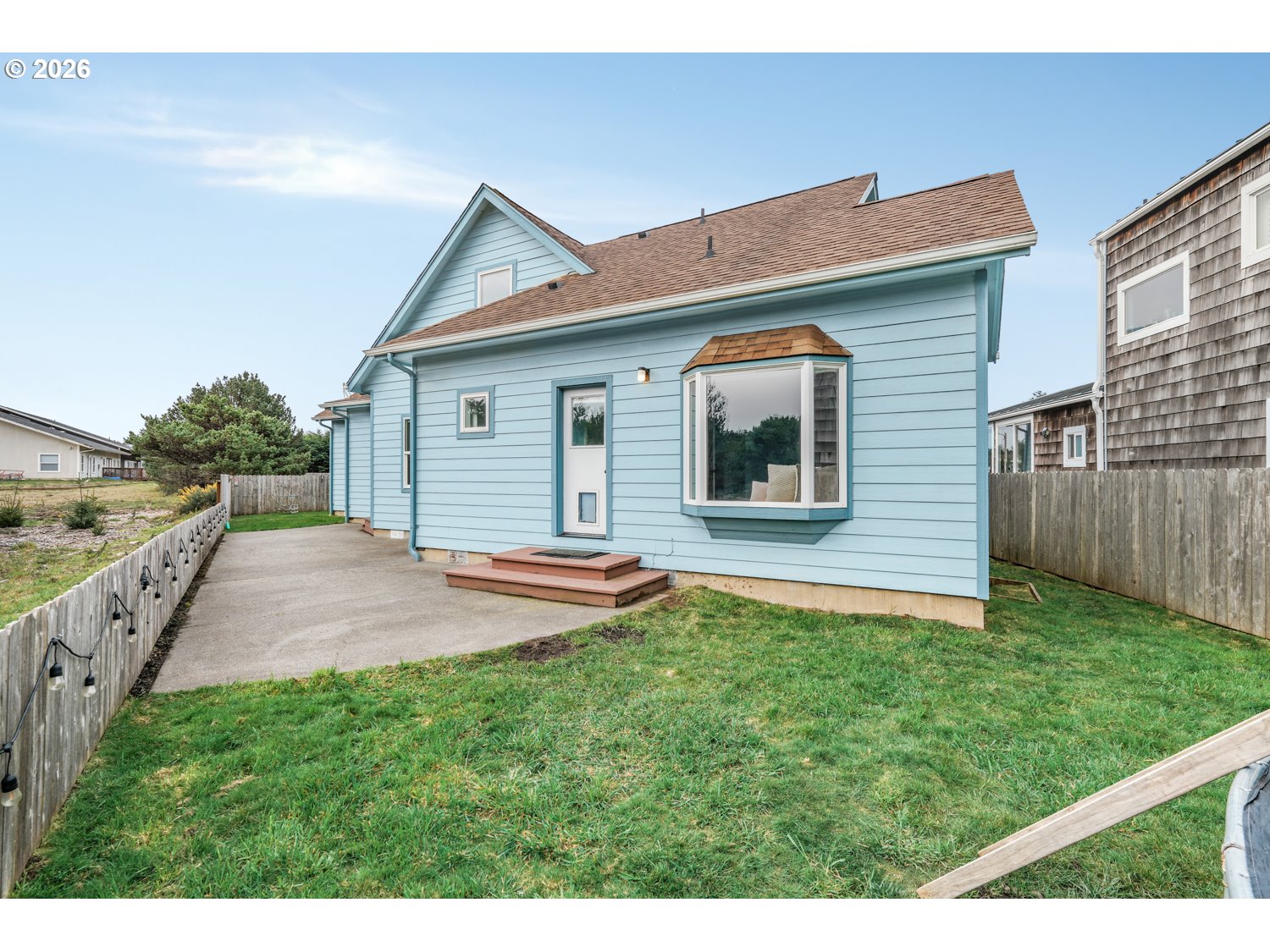2927 Ruby Court Bandon, OR 97411 - Photo 28 of 38 a front view of a house with a yard and garage
