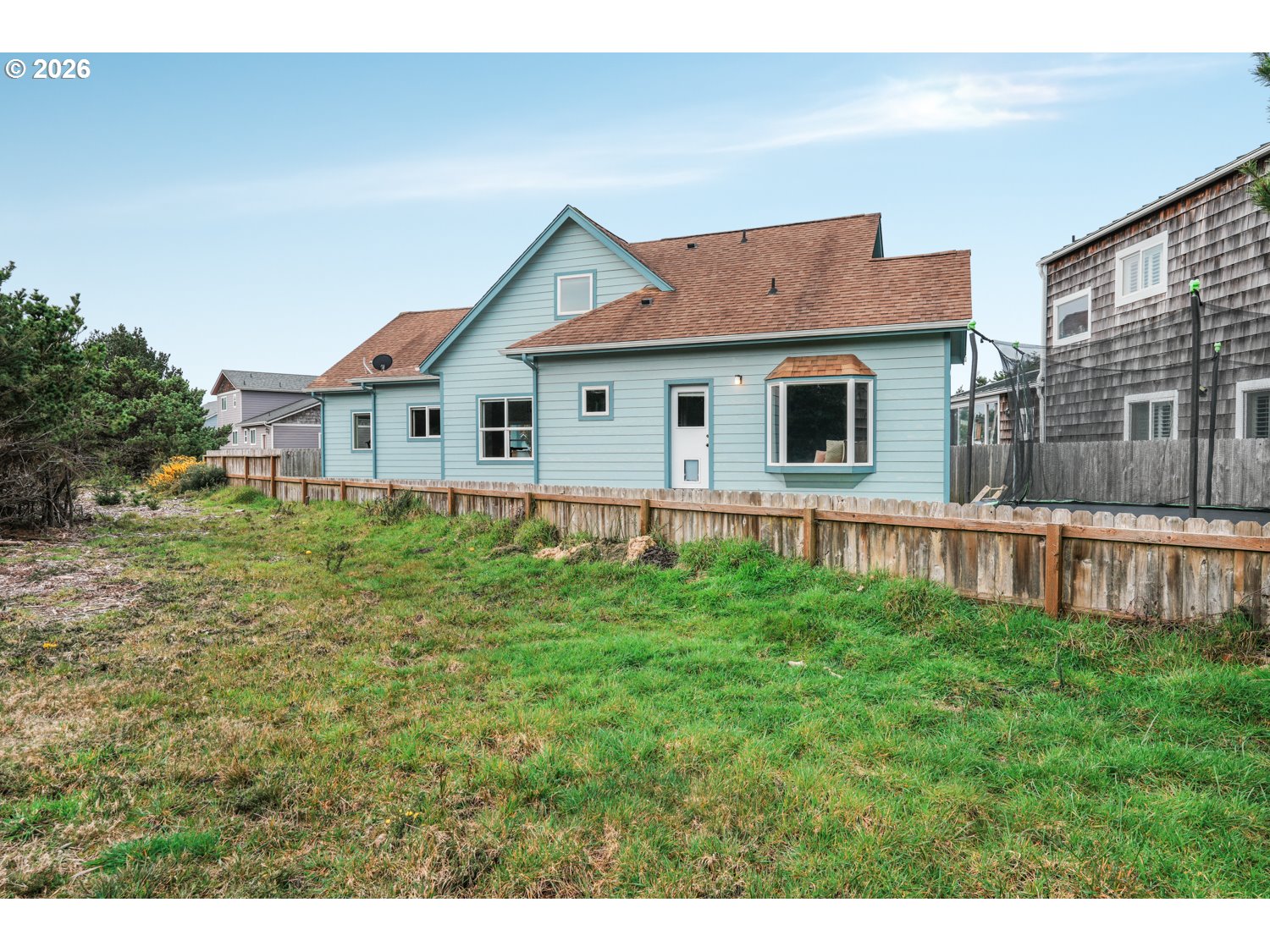 2927 Ruby Court Bandon, OR 97411 - Photo 29 of 38 a front view of a house with yard and green space