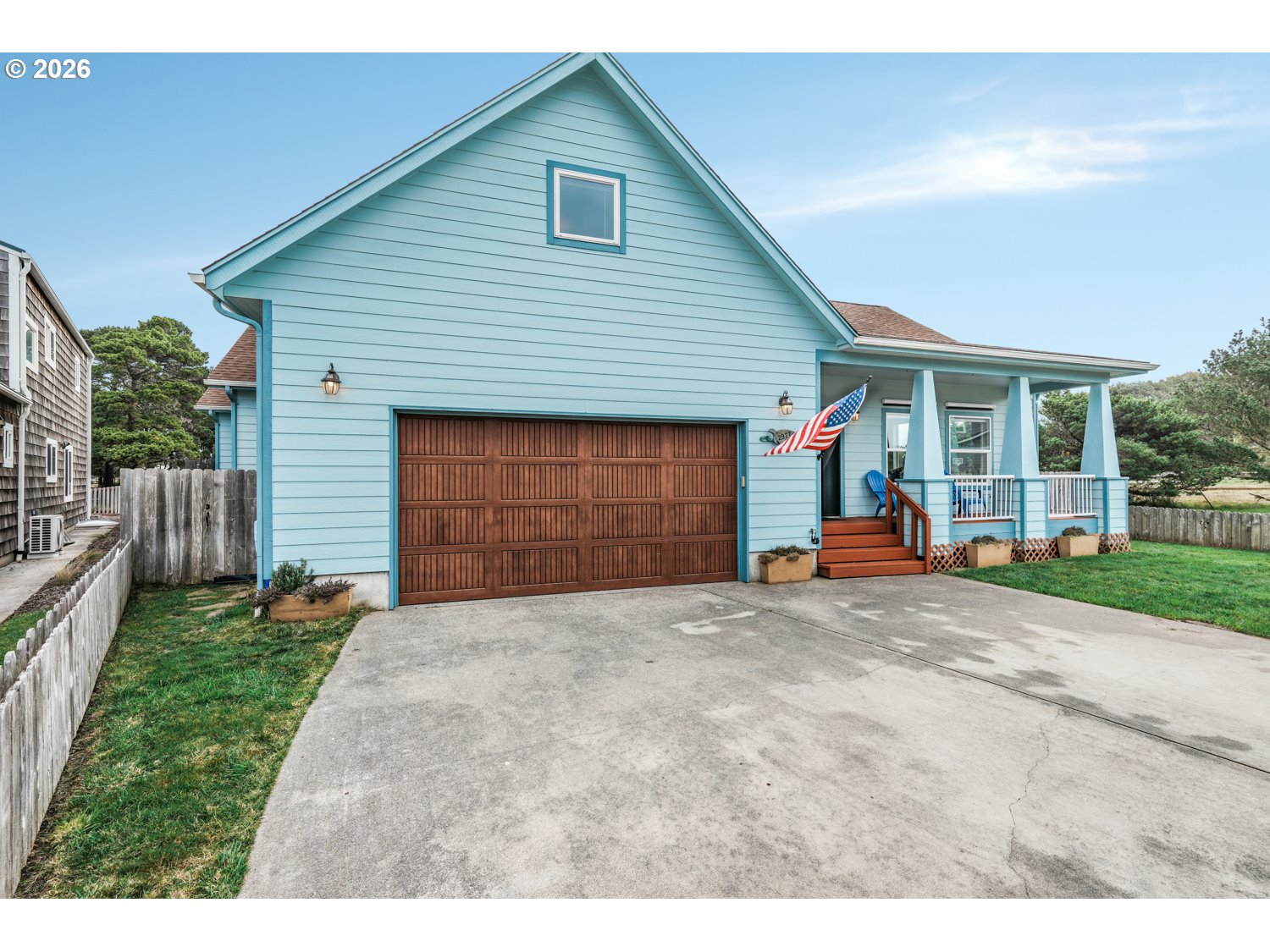 2927 Ruby Court Bandon, OR 97411 - Photo 32 of 38 a front view of a house with a yard and garage