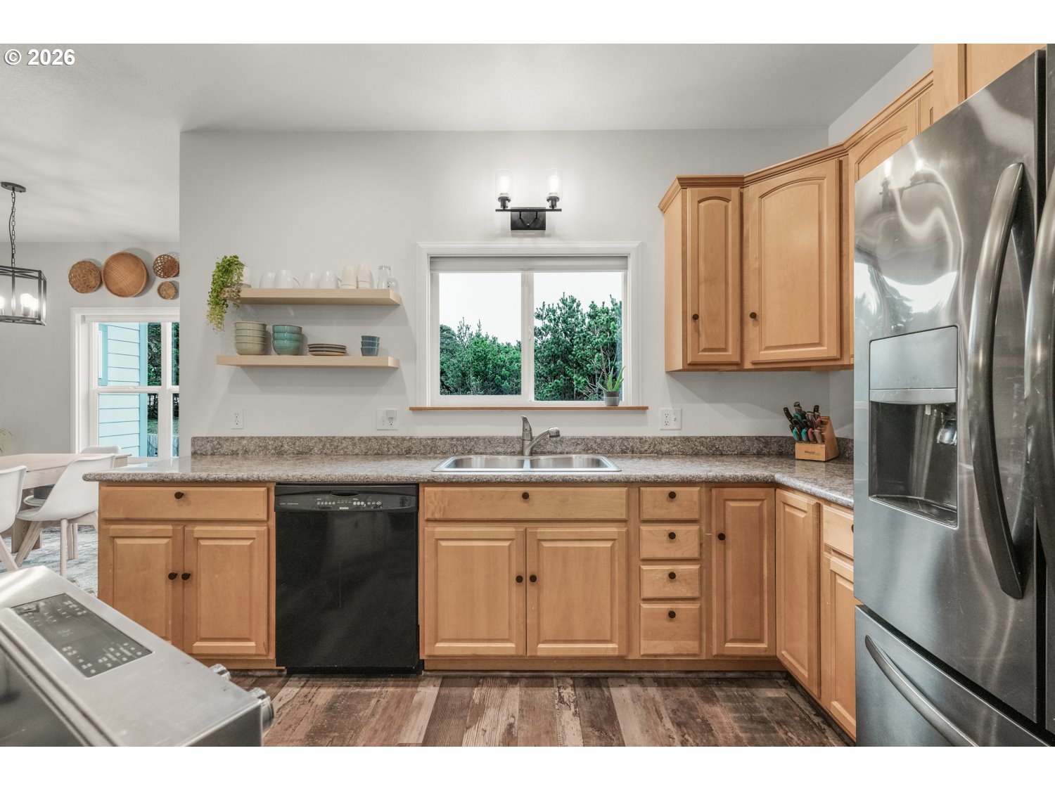 2927 Ruby Court Bandon, OR 97411 - Photo 8 of 38 a kitchen with stainless steel appliances granite countertop a sink stove and refrigerator