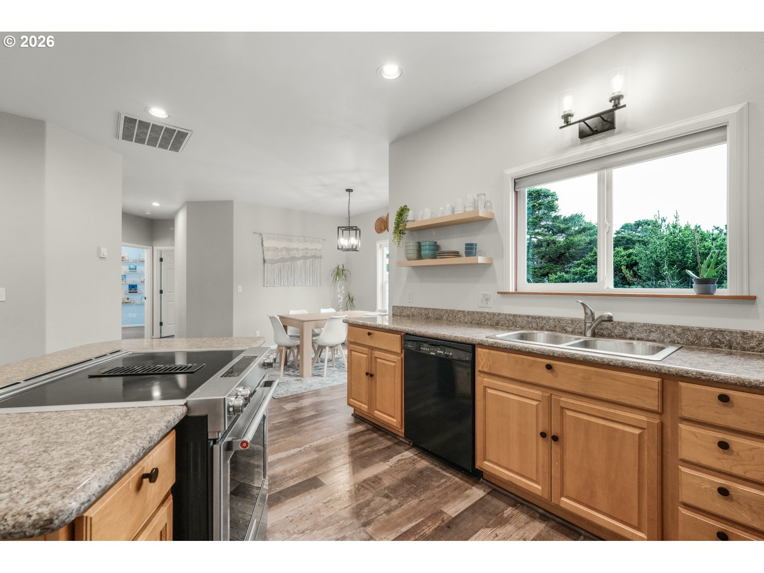 2927 Ruby Court Bandon, OR 97411 - Photo 9 of 38 a kitchen with granite countertop a sink stainless steel appliances and cabinets