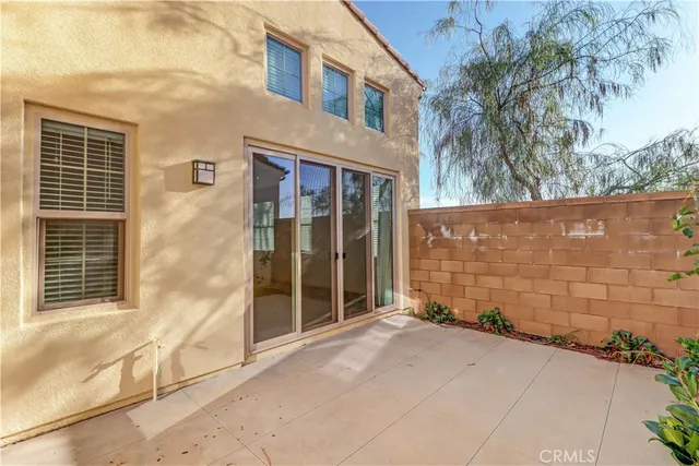 a view of a brick house with a large window