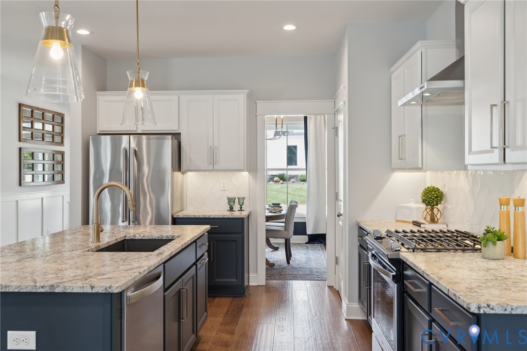 Lot 15 Robins Ridge Drive Moseley, VA 23120 - Photo 2 of 18 a kitchen with granite countertop a stove a sink dishwasher a refrigerator and wooden cabinets with wooden floor