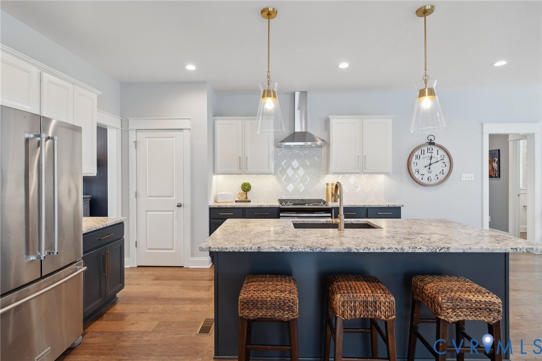 Lot 15 Robins Ridge Drive Moseley, VA 23120 - Photo 8 of 18 a kitchen with granite countertop stainless steel appliances and wooden floor