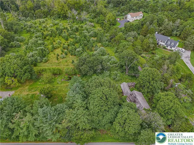 an aerial view of a house with lots of trees