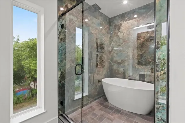 a view of an empty room with chandelier fan