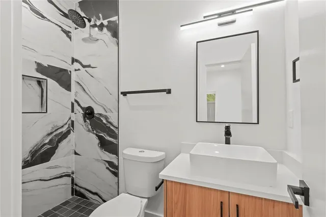 an empty room with closet and windows