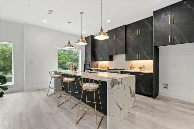 a kitchen with a sink cabinets and wooden floor