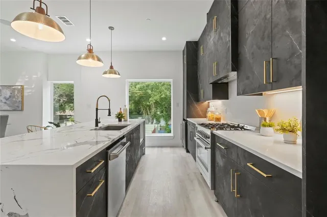 a kitchen with a sink stove and refrigerator