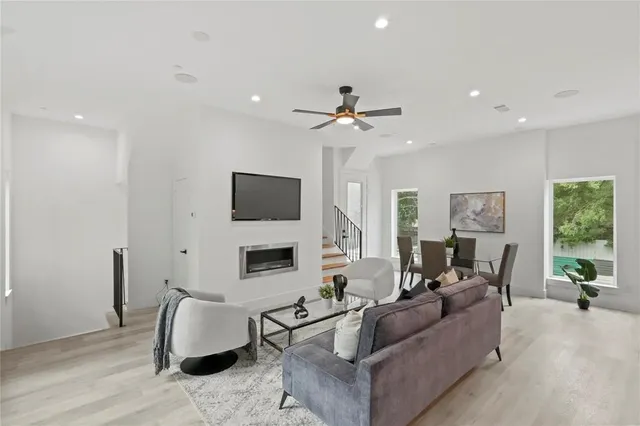 a living room with furniture a fireplace and a flat screen tv