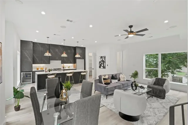 a living room with fireplace furniture and a large window