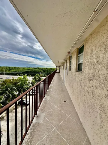 a kitchen with a sink a stove and cabinets
