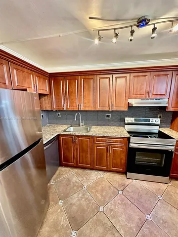 a kitchen with granite countertop a stove cabinets and a sink