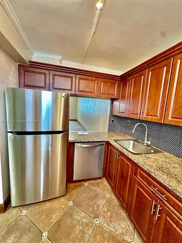 a kitchen with stainless steel appliances granite countertop a refrigerator a sink dishwasher with a stove and washer