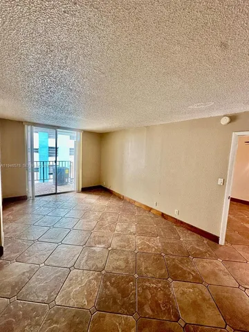 a view of an empty room with glass door