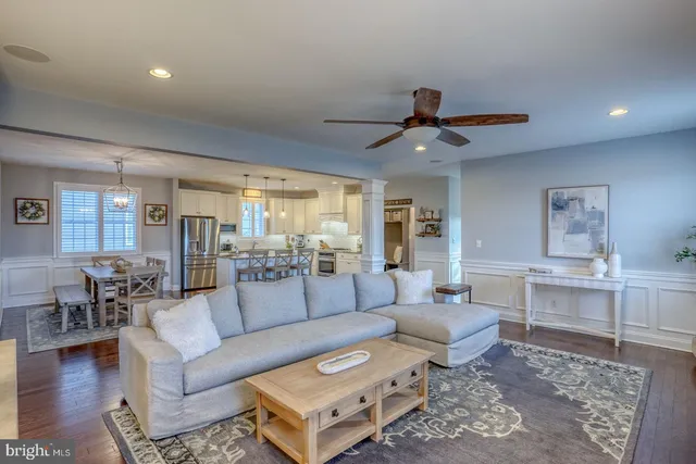 a living room with furniture a ceiling fan and a rug
