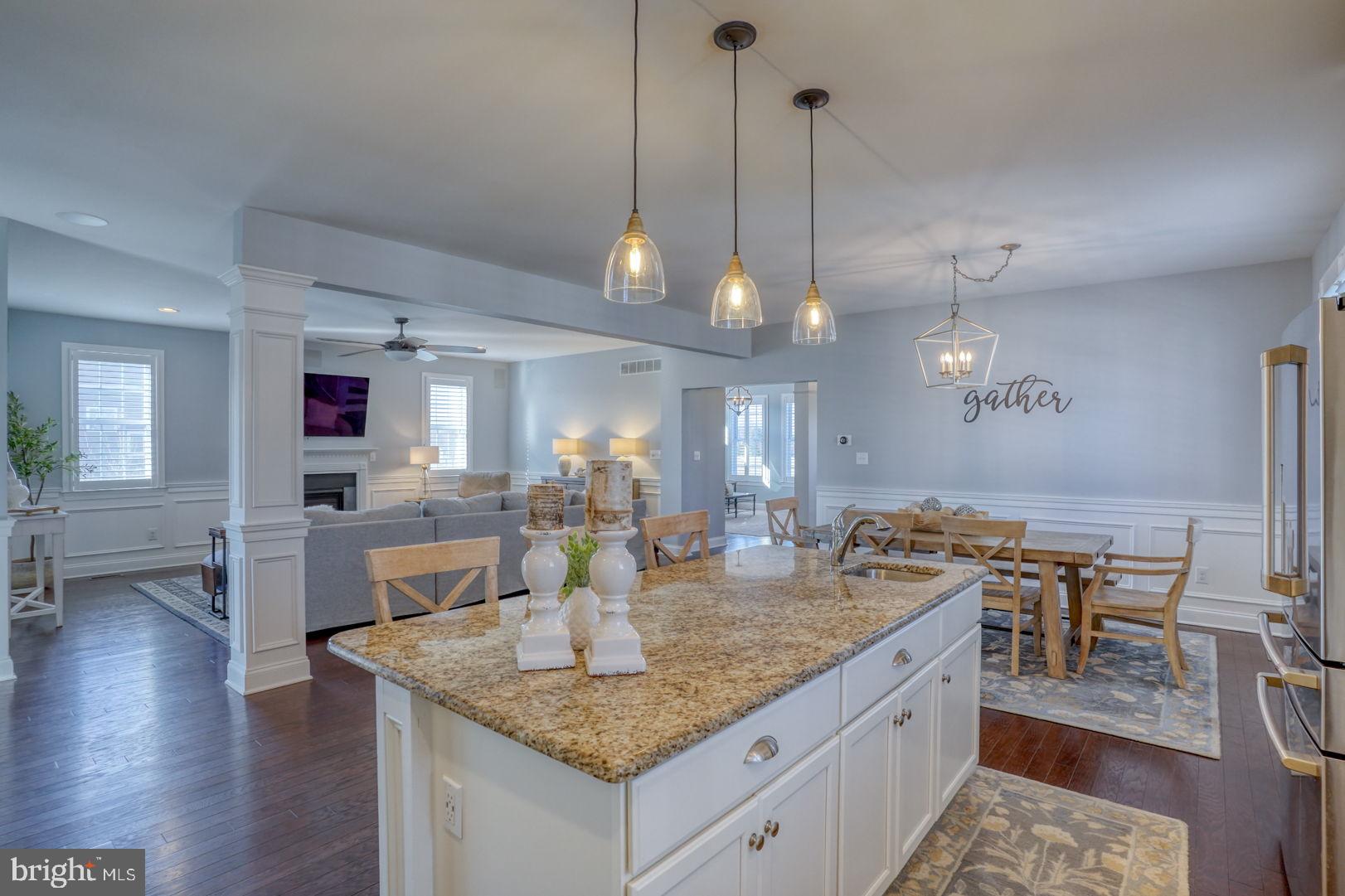 a kitchen with a counter space cabinets and wooden floor