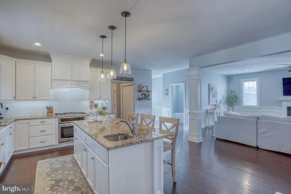a kitchen with a counter space cabinets and wooden floor
