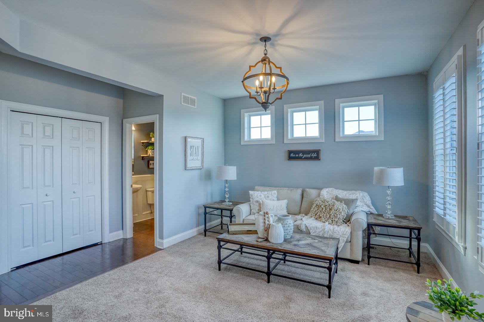 513 Spring Hollow Drive Middletown, DE 19709 - Photo 14 of 83 a living room with furniture a chandelier and a window