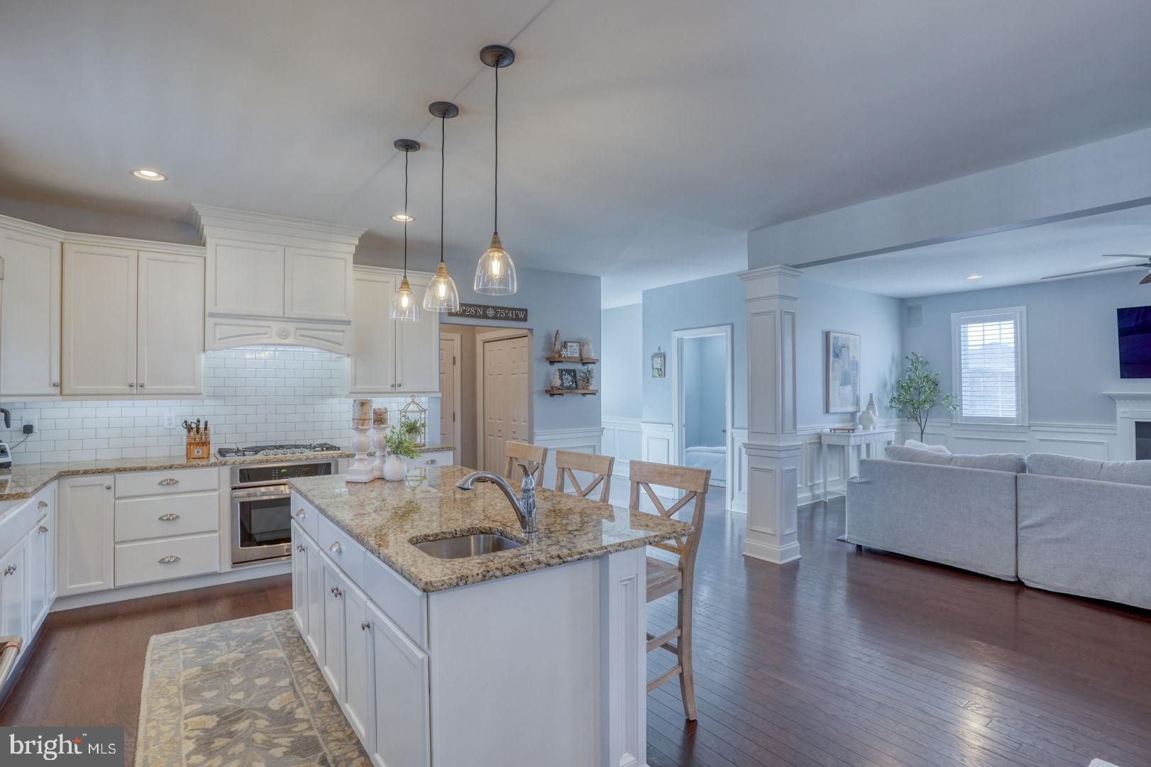 513 Spring Hollow Drive Middletown, DE 19709 - Photo 19 of 83 a kitchen with granite countertop a sink stove and refrigerator