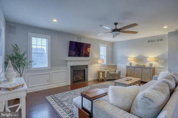 a kitchen with kitchen island granite countertop a sink a counter space appliances and cabinets