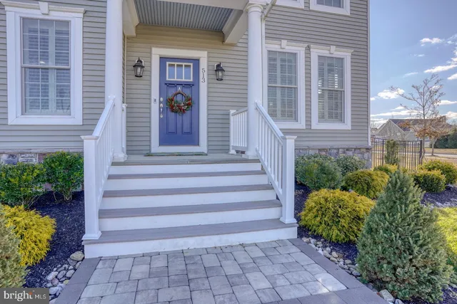 a living room with furniture a chandelier and a window