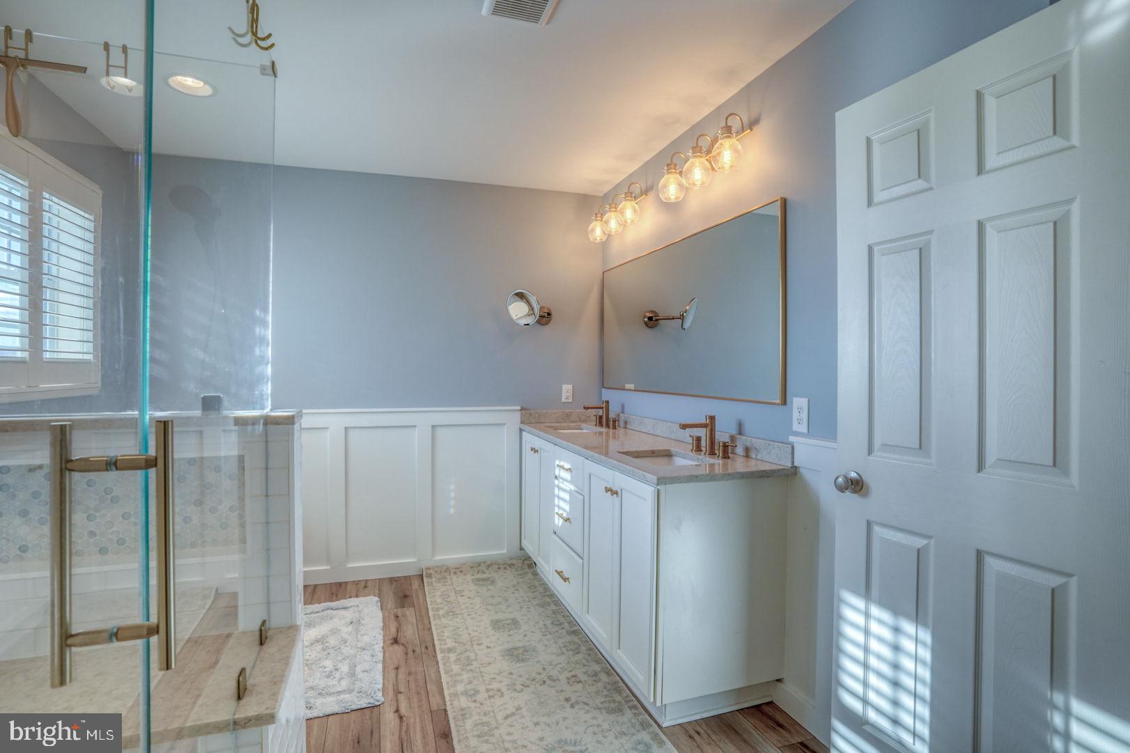 513 Spring Hollow Drive Middletown, DE 19709 - Photo 31 of 83 a bathroom with a granite countertop sink a mirror and a shower