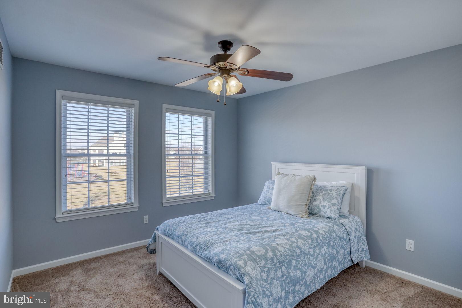 513 Spring Hollow Drive Middletown, DE 19709 - Photo 33 of 83 a bedroom with a bed and a chandelier