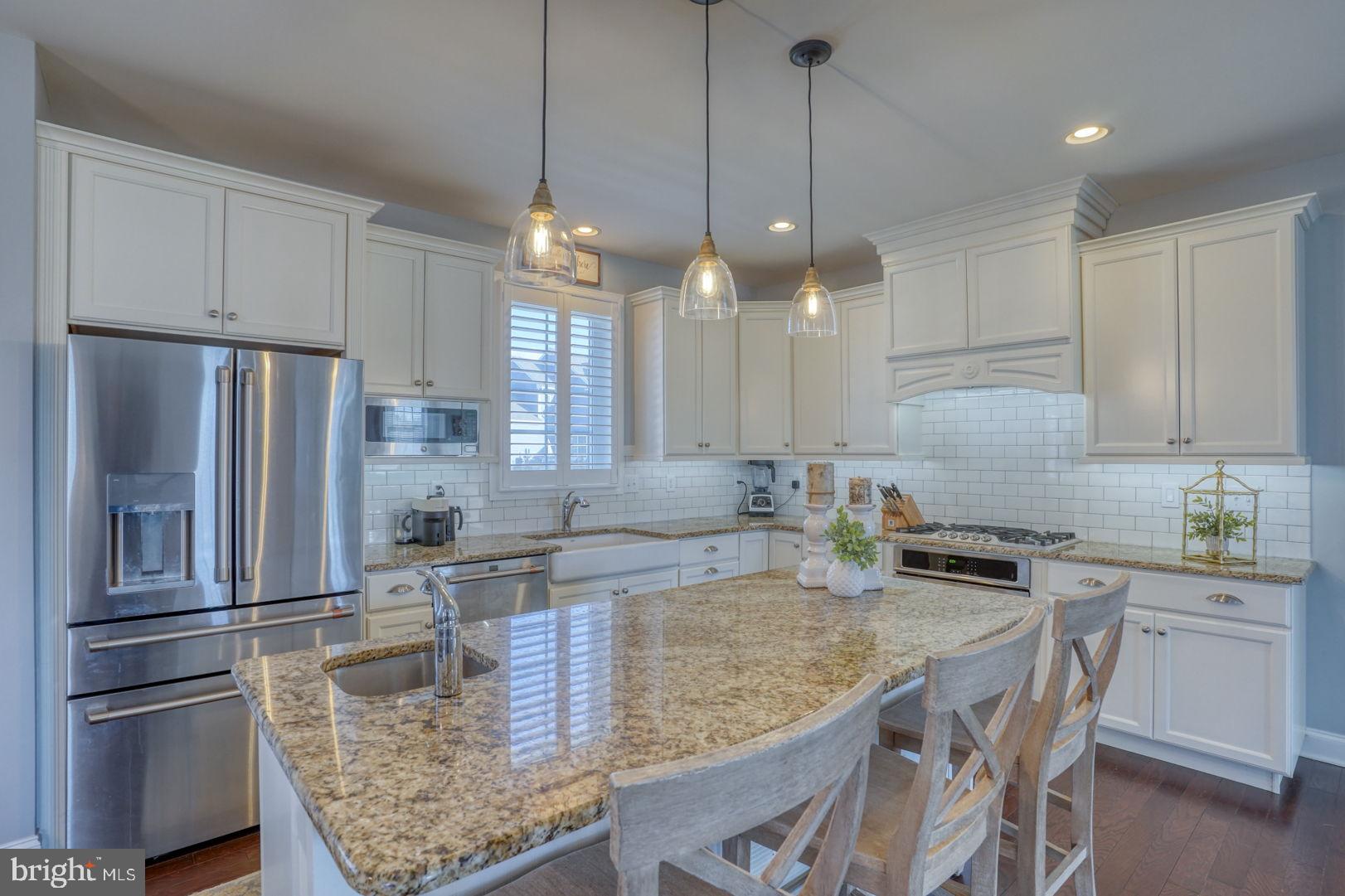513 Spring Hollow Drive Middletown, DE 19709 - Photo 4 of 83 a kitchen with kitchen island granite countertop a sink a counter space appliances and cabinets