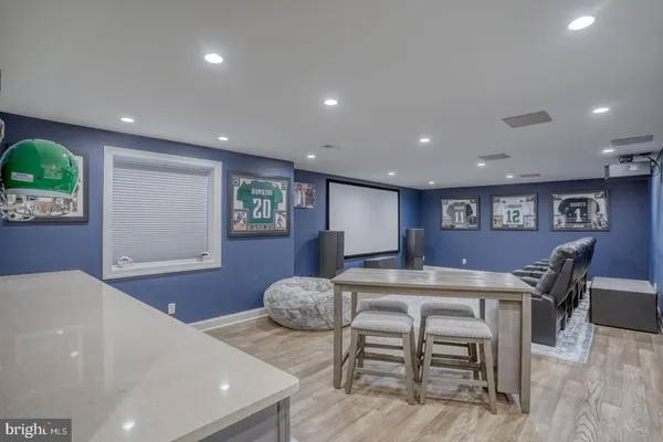 an empty room with wooden floor and a kitchen space