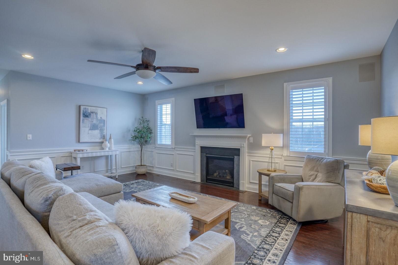 513 Spring Hollow Drive Middletown, DE 19709 - Photo 6 of 83 a living room with furniture a fireplace and a flat screen tv