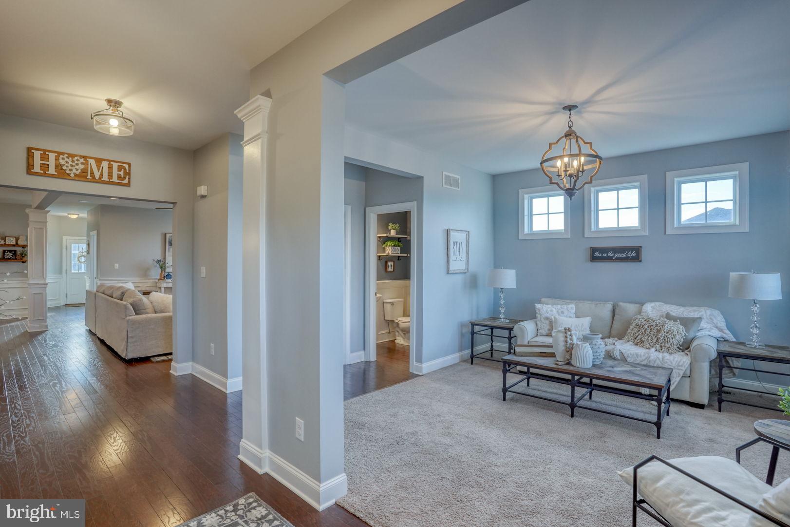 513 Spring Hollow Drive Middletown, DE 19709 - Photo 10 of 83 a living room with furniture and a chandelier