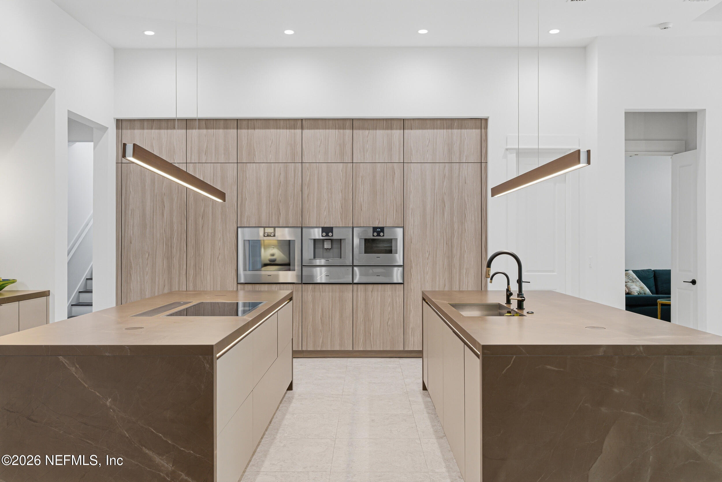 4640 Palm Vly Road Ponte Vedra Beach, FL 32082 - Photo 15 of 72 a kitchen with kitchen island granite countertop a sink and cabinets