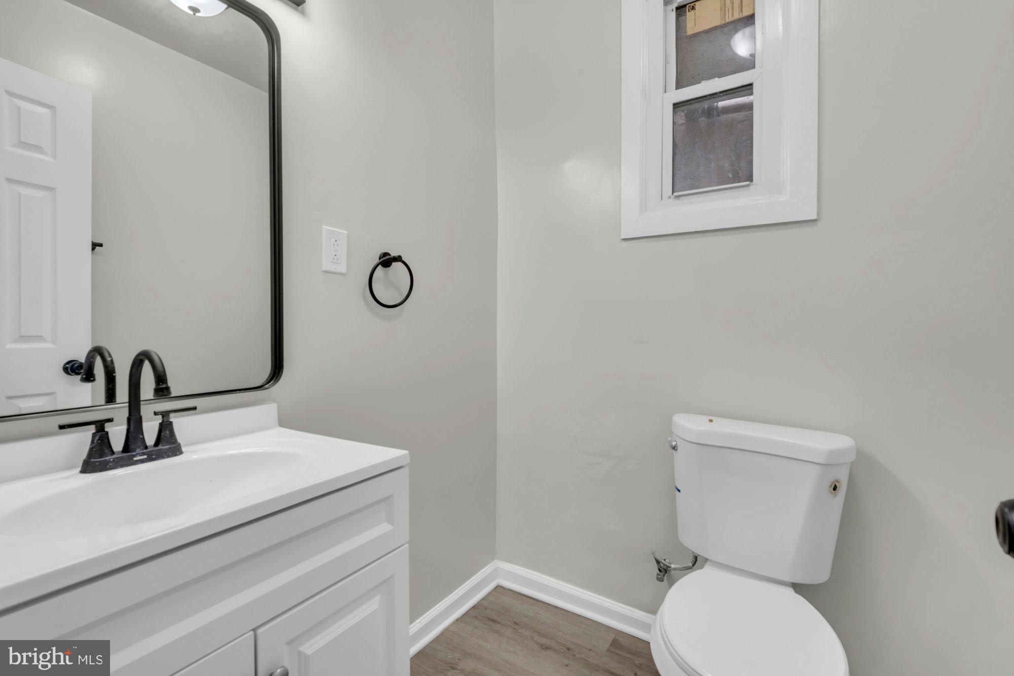 1904 Kennedy Avenue Baltimore, MD 21218 - Photo 15 of 29 a bathroom with a toilet sink and mirror
