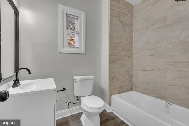 a bathroom with a toilet sink and bathtub