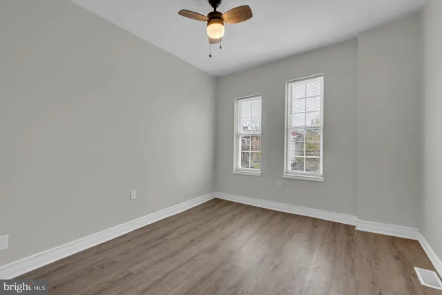 wooden floor in an empty room with a window