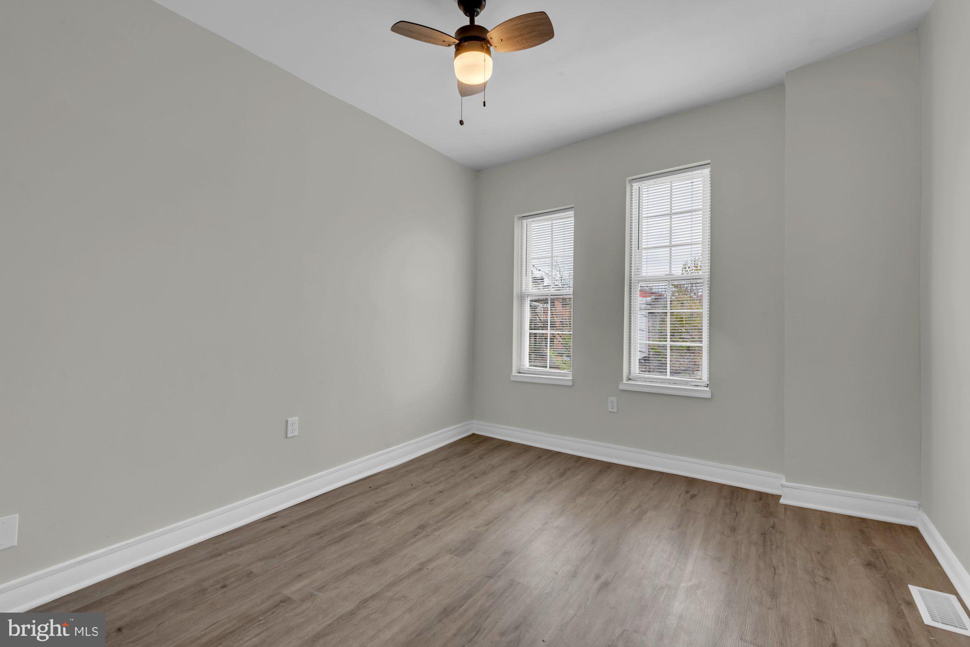 1904 Kennedy Avenue Baltimore, MD 21218 - Photo 22 of 29 wooden floor in an empty room with a window