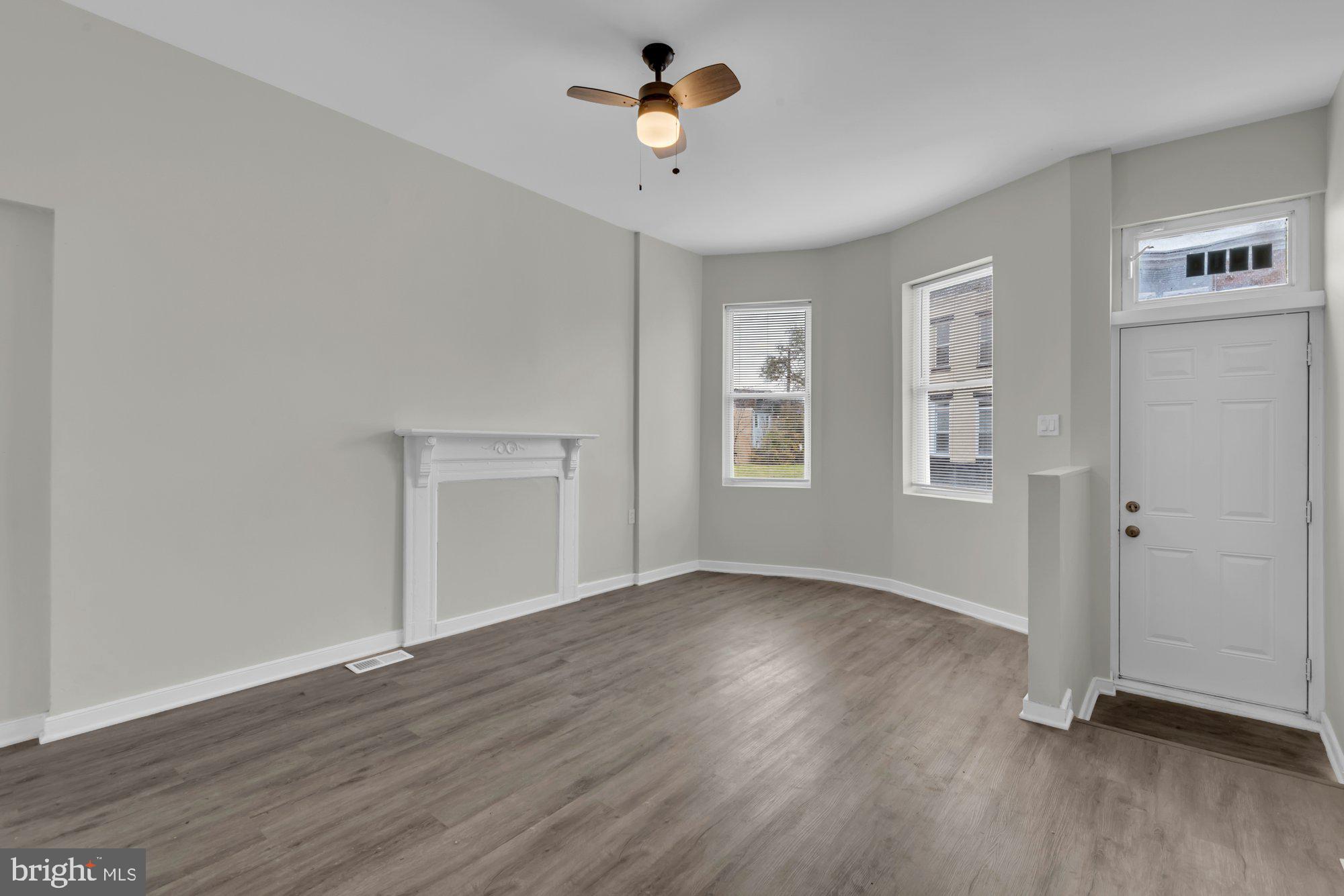 1904 Kennedy Avenue Baltimore, MD 21218 - Photo 5 of 29 a view of an empty room with a window and wooden floor