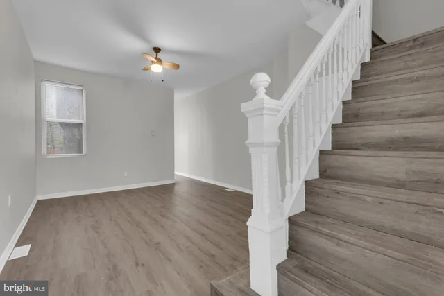 a view of entryway and hall with wooden floor