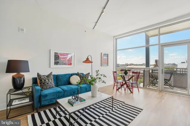 a living room with furniture and floor to ceiling windows