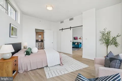 a bedroom with a bed and a couch