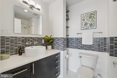 a bathroom with a sink a toilet and mirror