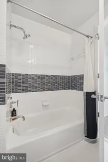 a bathroom with a bathtub and a shower