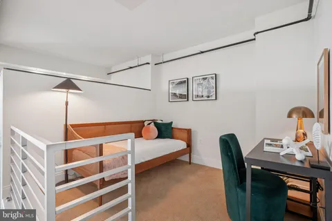 a bedroom with a workspace