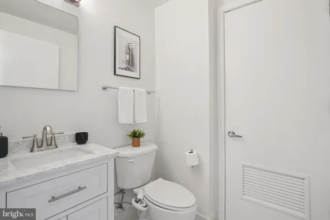 a bathroom with a toilet a sink and mirror