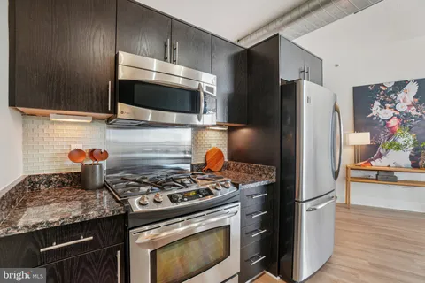 a kitchen with a stove and a refrigerator