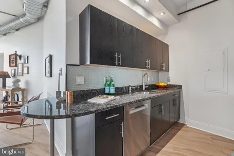 a kitchen with granite countertop a sink and a stove