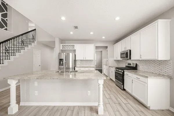 a kitchen with a sink and cabinets