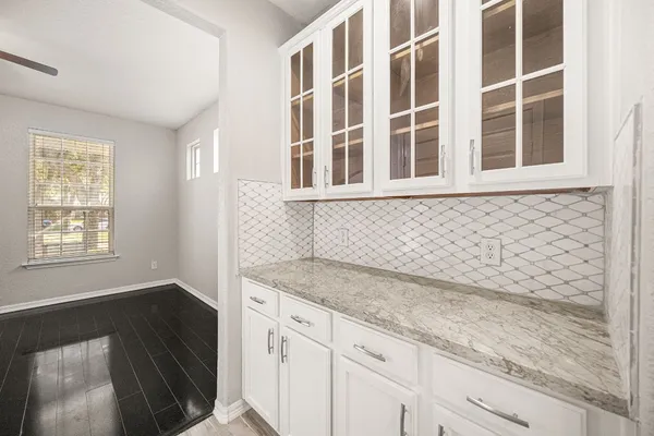 a bathroom with a glass shower door and a glass door