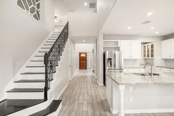 wooden floor fireplace and windows in an empty room